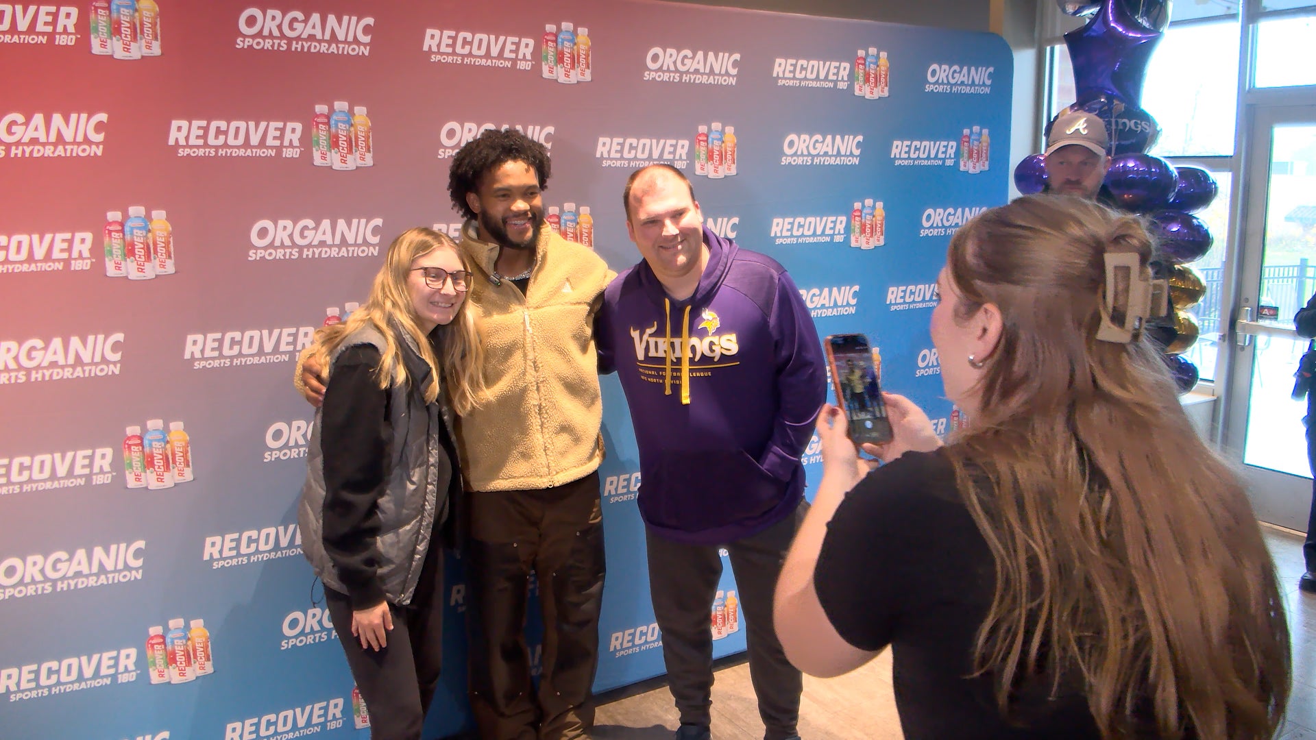 Kyler Murray smiling and interacting with fans at a Hy-Vee event in New Hope, Minnesota